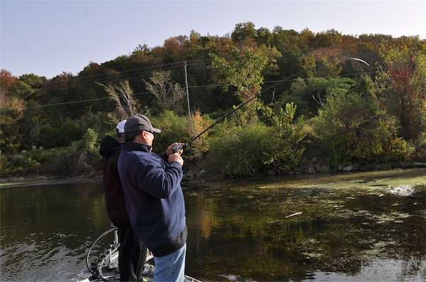 <p> </p>
<p>The early morning bite: John Holtman reels one in from the milfoil.</p>
