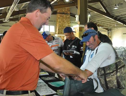 <p>Darin Doll, right, of Pennsylvania gets his Cabela's gift pack from B.A.S.S. staffer Eric Nichols.</p>
