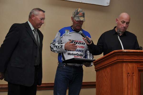 <p>Andy Bravence accepts his award for placing 10th in the tournament and earning a 2013 Bassmaster Classic qualification.</p> 