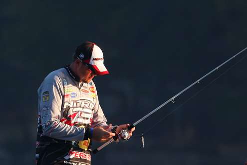<p> </p> <p>Williamson hooks his bait to his rod as he prepares to move. </p> 