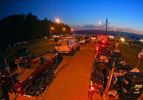 <p>Two lanes of trucks and boats make their way to the launch ramp.</p> 