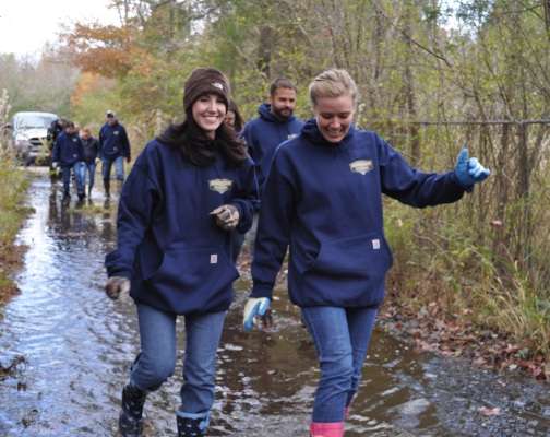 <p>Jennifer Leonard and Amanda Gale navigate a flooded road to make it to the worksite.</p>
