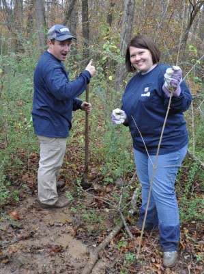 <p>Hank Weldon and Emily Hand, who make up the College B.A.S.S. team, work in a marshy area.</p>
