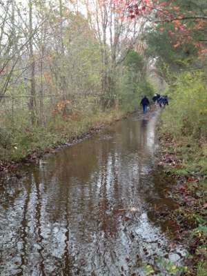 <p>B.A.S.S. staff walked down a flooded pathway to get to the worksite.</p>
