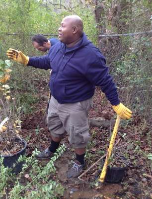 <p>Torrance Johnson and Rick Reed plant native bushes in the areas that have been cleared.</p>
