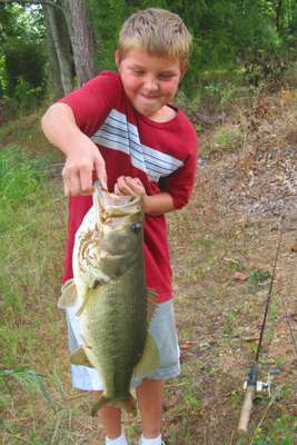 <p>
	Joshua McDowell shows off his biggest bass yet.</p>

