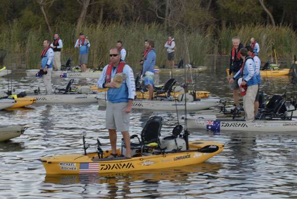 <p>SHOWING RESPECT: Competitors from 12 nations stand in their Hobie kayaks as the national anthem of the United States of America plays across the waters of Fayette Lake. </p>
