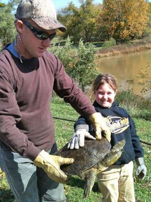 <p>Brent Chapman spends time with his family when theyâre all home in Lake Quivira, Kan. Here, he and his daughter, Makayla, show off a turtle they found.</p>
