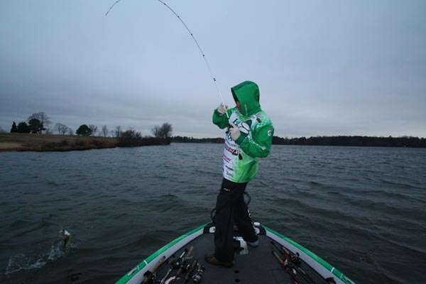 <p>8:15 a.m. Tucker prepares to swing aboard a bass that hit his jerkbait on a steep bank while facing an approaching snowstorm.</p>

