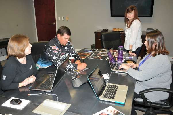 <p>Lane sneaks in one more autograph before the Twitter chat begins. Tyler Reed, Helen Northcutt and Jennifer Dome prepare to type his answers to fans into Twitter so he can concentrate on the content of his answers. "I don't type," he said, laughing.</p>
