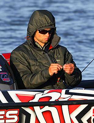 <p>Palaniuk takes a second to tie on a Wiggle Wart at his first spot on Sunday morning.</p>
