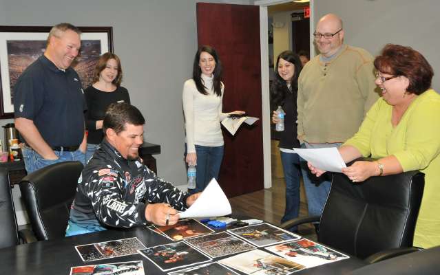 <p>Lane signed autographs on photos from his 2012 Bassmaster Classic win for B.A.S.S. employees.</p>
