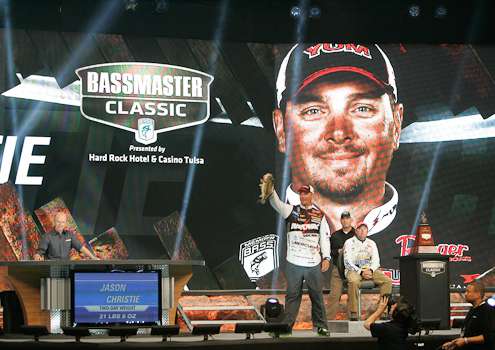 <p>Jason Christie holds up a fish for the crowd as Mike McClelland looks on.</p>
