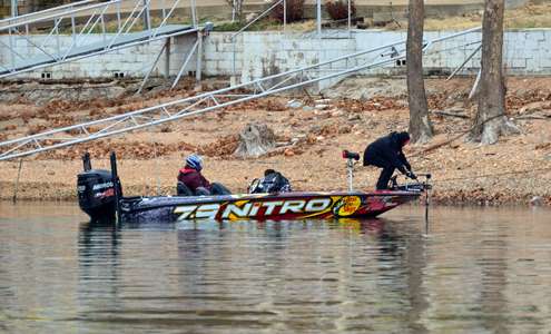 <p>Kevin VanDam spent much of his morning working a jerkbait around docks, which are secured to the shore via many cables. Here he frees his bait from one such cable.</p>
