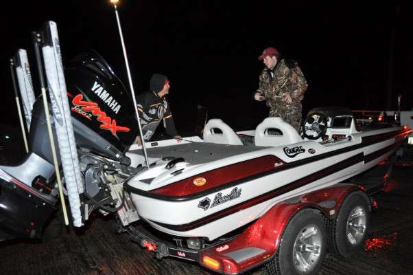 <p>Oklahoma State University's Caleb Masters helps B.A.S.S. employee Tony Quick check his boat.</p>
