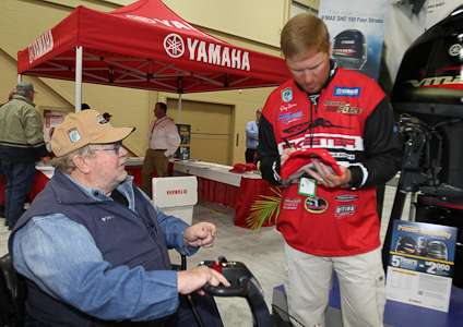 <p>Elite Series pro Greg Vinson signs an autograph in the Yamaha booth.</p>
