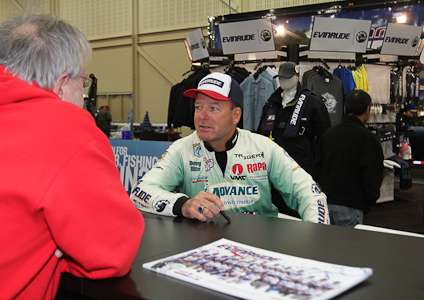 <p>Elite Series pro Davy Hite signs autographs in the Evinrude booth.</p>

