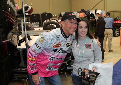 <p>Elite Series pro Kevin Short poses for a picture with a fan in the Bass Cat Boats booth.</p>
