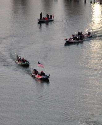 <p>A flag boat leads Cliff Pace out as they head out in order of the Day Two standings.</p>

