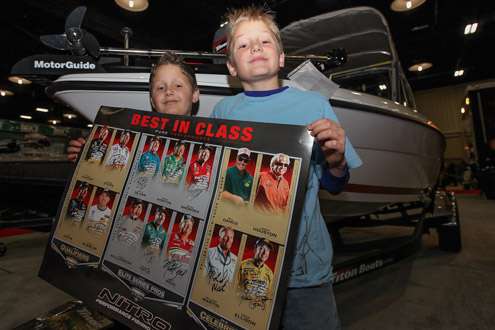 <p>Cole, 8, and Cody, 9, both from Bixby, Okla., get a poster signed at the expo.</p>
