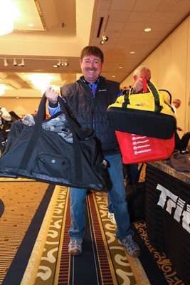 <p>Shaw Grigsby holds up bags of awesome freebies from registration.</p>
