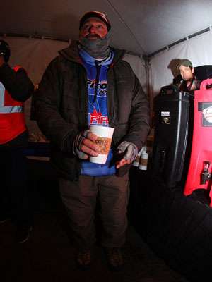 <p>Shaw Grigsby tries to stay warm before takeoff. This was the third straight day that started with freezing temperatures.</p>
