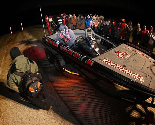 <p>Greg Hackney launches his boat in front of a group of fans.</p>
