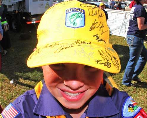 <p>A Cub Scout shows off his hat full of autographs behind the stage of the Bassmaster Elite Series event on the Sabine River.</p>
