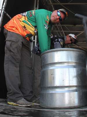 <p>Dennis Tietje rests against a holding tank while waiting to weigh. Tietje stumbled on Day One but has steadily climbed the standings and sits in 9th place after three days.</p>
