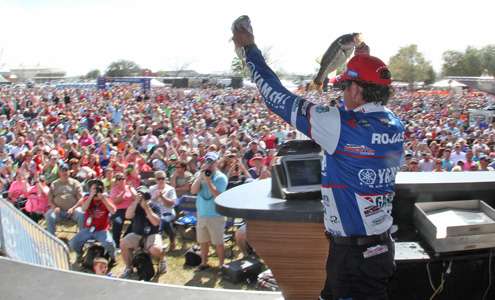 <p>Dean Rojas hoists his two best fish Saturday to a packed house of spectators.</p>

