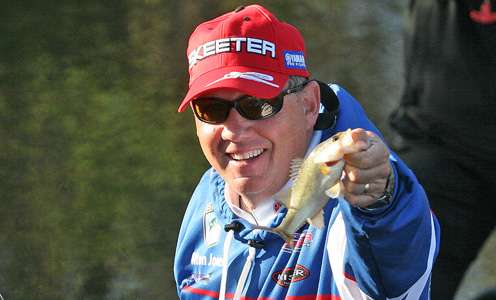 <p>Alton Jones has fun showing off a small fish. You know, if you hold it close to the camera it looks bigger.</p>
