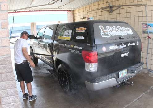 <p>Cliff Prince washes off his truck.</p>

