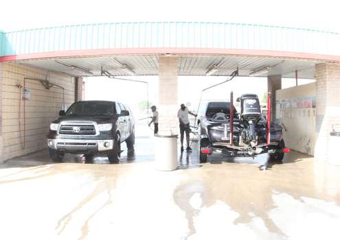<p> </p>
<p>Prince (left) and Williamson (right) fill up the car wash in Zapata.</p>
