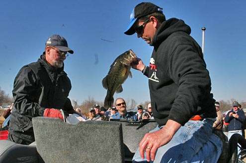 <p>Pace, who went on to win his first Classic, digs into another livewell for another nice bass he displayed to the crowd.</p>
