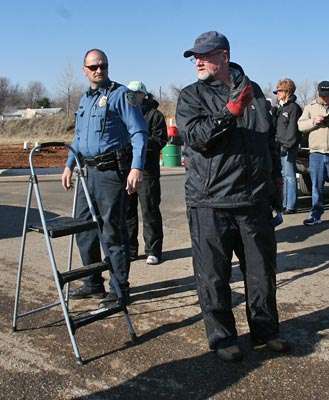 <p>Leatherwood watches for cross traffic, spectators and boats leaving the main parking lot, as he directs the next boat driver in line to move up. He used the ladder to climb aboard each of the anglersâ boats.</p>
