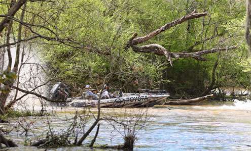 <p>Scroggins powers his boat through the logs and stumps blocking the exit to the river. </p>
