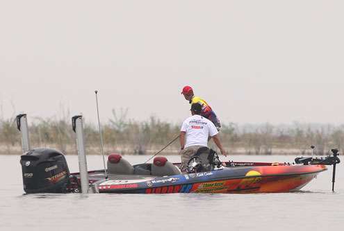 <p>Combs hooks another small bass and his Day Two Marshal moves in to view the action. </p>

