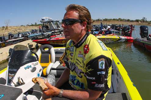 <p>Skeet Reese takes a moment to get a bite to eat after weighing in. He finished 27th with 65-10 after Day Three.</p>
