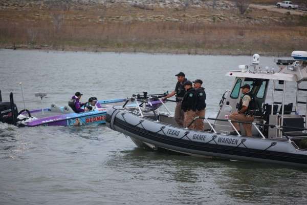<p>The Texas Game Warden deputies look on.</p>
