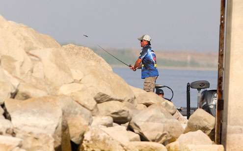 <p>Kelley Jaye casts a drop bait into the rip rap wall of the dam. </p>
