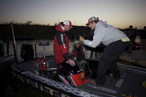 Shaye Baker of the Bassmaster.com staff provides Jason Williamson with some last minute instructions about the Go Pro camera attached to his windshield.
