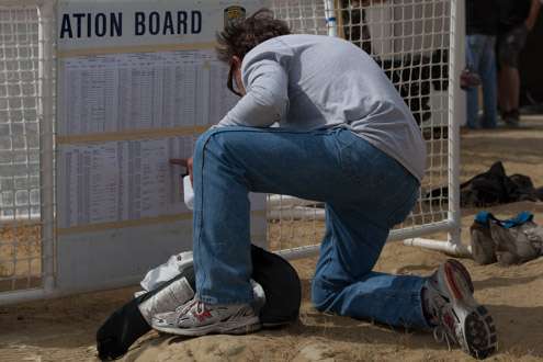 <p>A Marshal checks the board during the weigh-in Thursday.</p>
