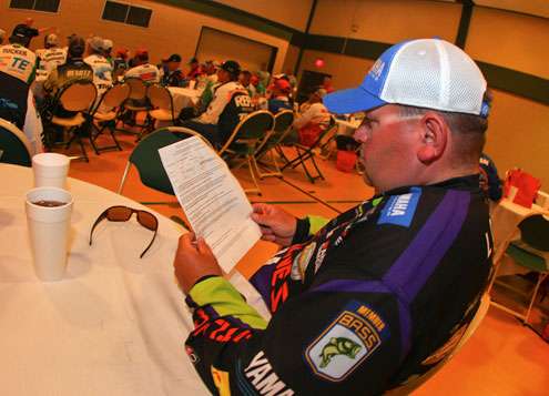 <p>Bill Lowen follows along on the rules sheet given to every competing angler. </p>
