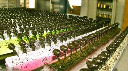 There's a three-step process in the painting of these football head jigs: 1) a powder paint coat, 2) art work, like eyes, or the black accents on the olive-colored jigs pictured in the front rows, and 3) an auto-type clear coat to preserve the previous paint layers.