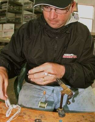 <p>Pace demonstrates how to tie a new skirt on a buzzbait. Pace and Gary Klein, who usually share a room while on the road for Elite Series events, always carry tying vises, bobbins and spools of thread when traveling. Pace carries a considerable supply of various silicone skirts for jigs, spinnerbaits and buzzbaits. "It gives you an unlimited resource to pull from," Pace said.</p>
