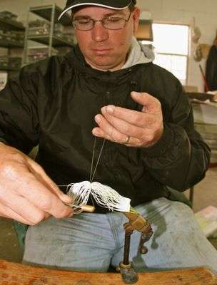 <p>Pace puts the finishing wraps on the buzzbait skirt. Bayou Outdoors in Natchitoches, La., makers of V&M and Cyclone lures, is one of Pace's primary sponsors, and he has designed many of their baits. His lure-making is an off-shoot of that. "No single tackle company can carry an inventory of everything," Pace said. "They'd have to have a warehouse the size of Texas." By having the ability to make or modify lures almost instantly, "I've always got whatever I need with me," he said. "That's invaluable."</p>
