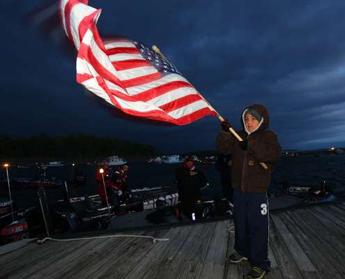 The flag held during the national anthem whips in the wind on the cold morning.