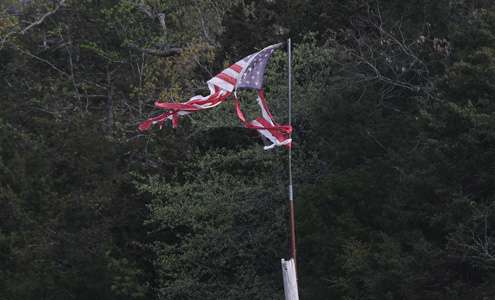 <p>An American flag that has seen better days gives a good indicator of the wind blowing into the creek.</p>
