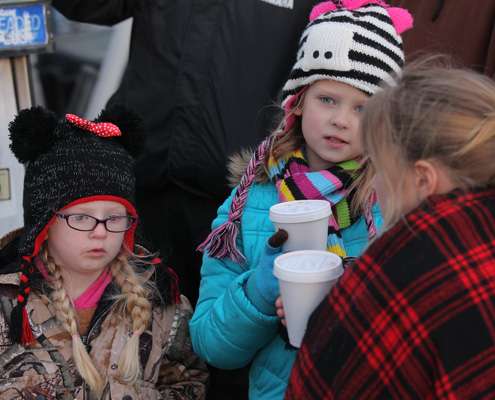 Young girls watching the take-off warm up with hot chocolate.