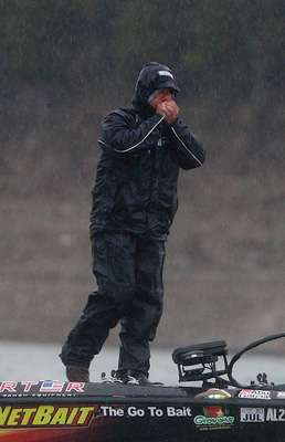 Poche stops fishing to try to warm his hands from the cold rain that moved in just after launch time.
